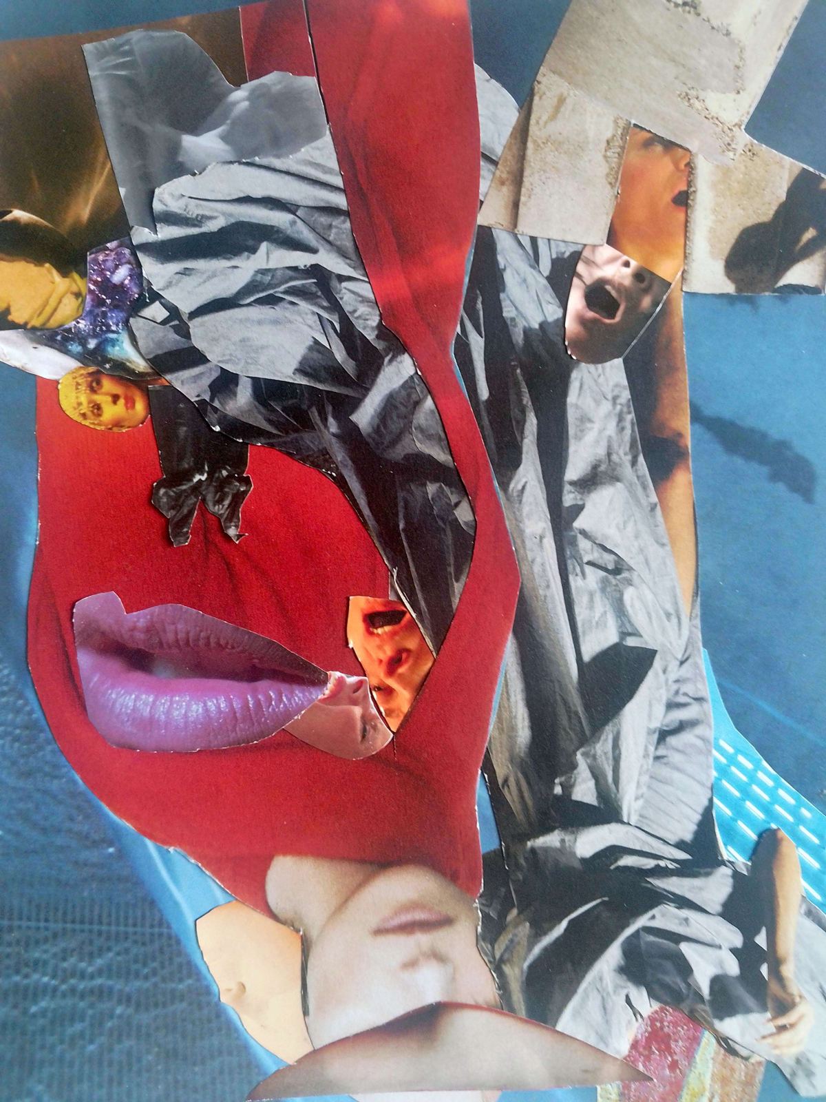 Collage: red cut-out figure with lips on grey and blue paper